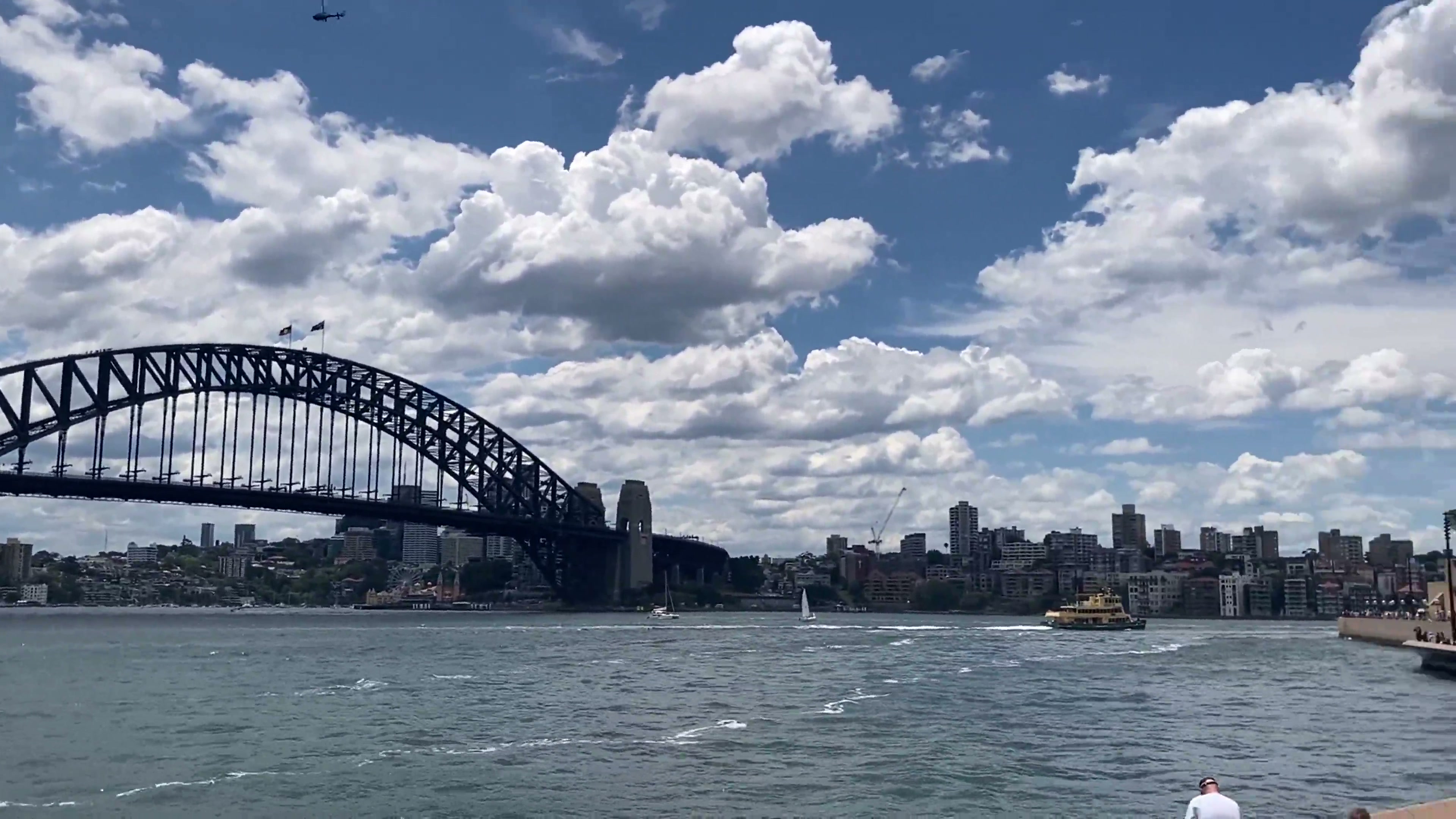 A real 4K film still of Sydney Harbour under a broad summer sky